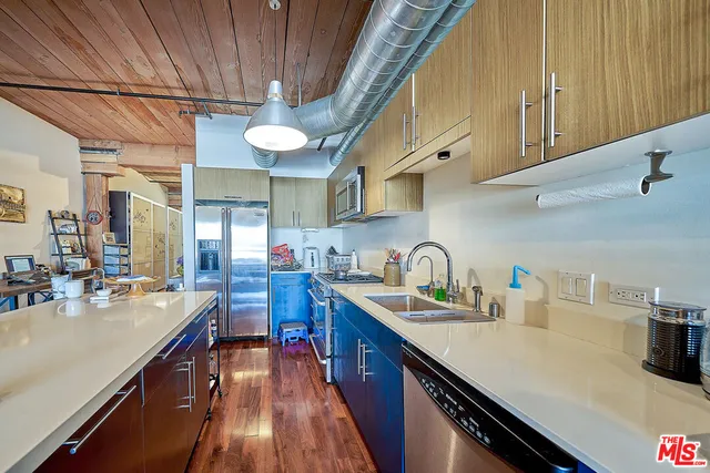 a kitchen with cabinets a sink and appliances
