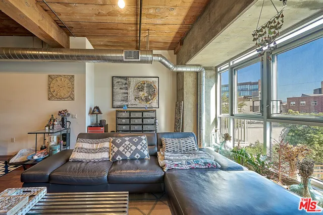 a living room with furniture and a floor to ceiling window