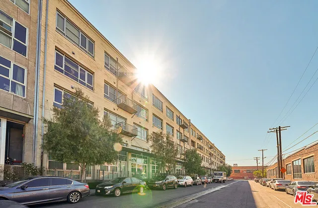 a couple of cars parked in front of a building