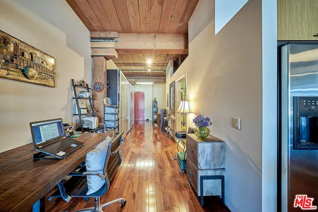 a workspace with furniture entryway and wooden floor