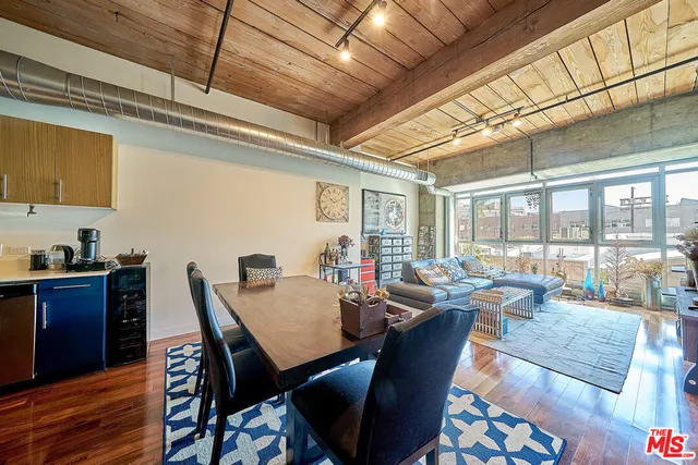 a view of a dining room with furniture large windows and wooden floor