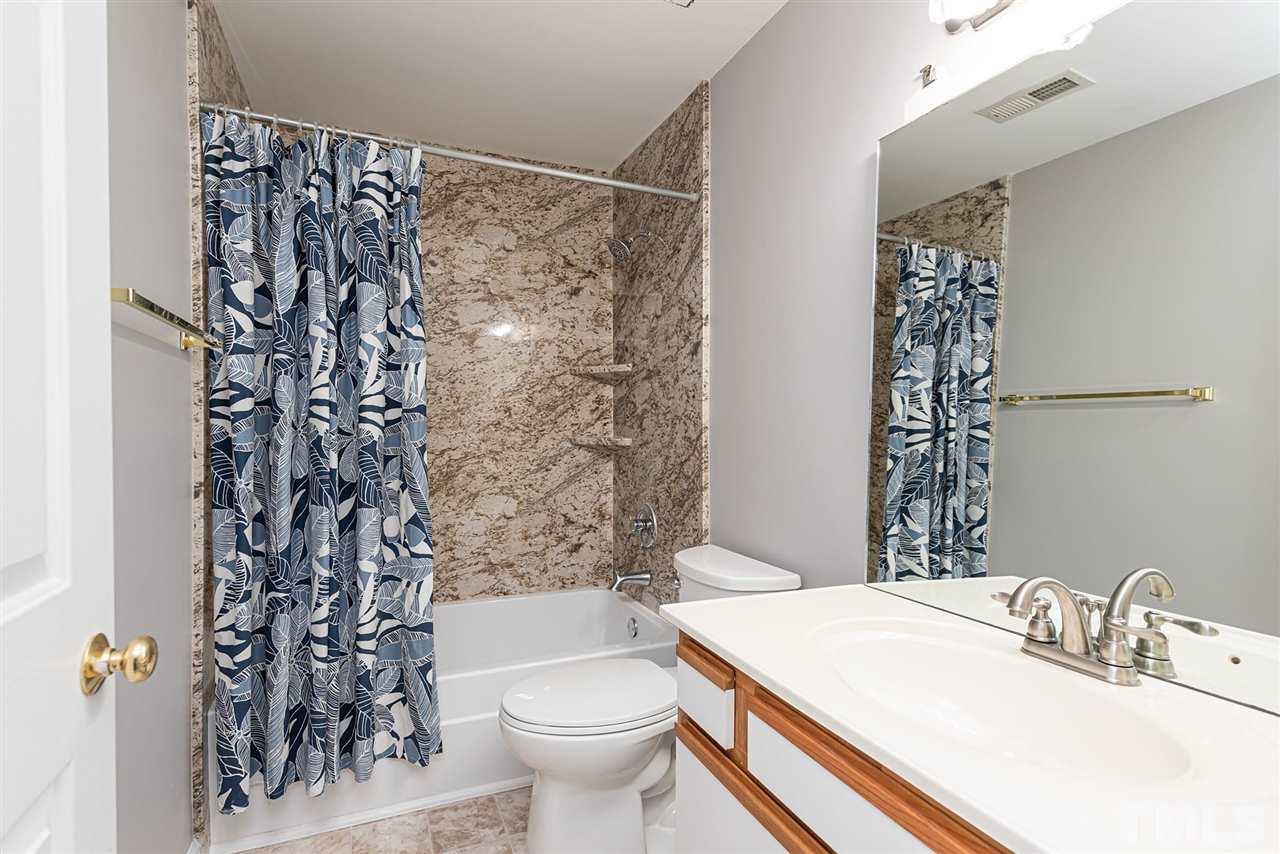 6305 Daystar Lane Raleigh, NC 27613 - Photo 11 of 19 a bathroom with a sink toilet and shower