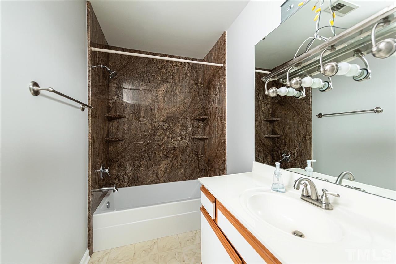 6305 Daystar Lane Raleigh, NC 27613 - Photo 16 of 19 a bathroom with a sink and a mirror