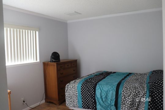 318 South Gordon Street Ridgecrest, CA 93555 - Photo 16 of 27 a bedroom with a bed and a window