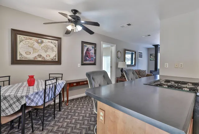 a view of a dining room with furniture and chandelier