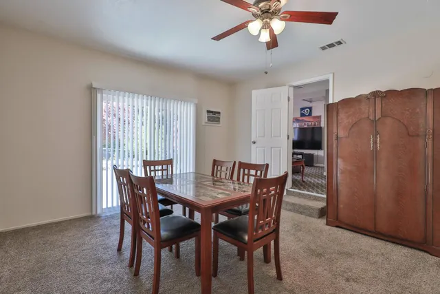 a dining room with furniture and window