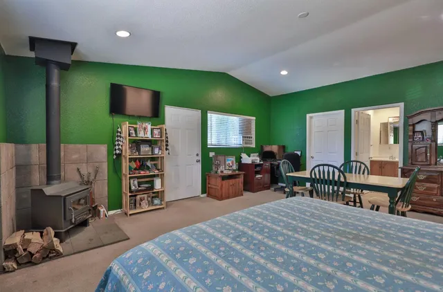 a bedroom with furniture and a flat screen tv