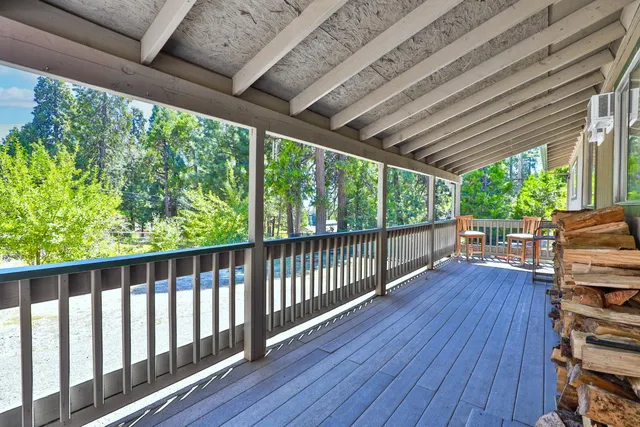 a view of a porch with wooden floor in outdoor space