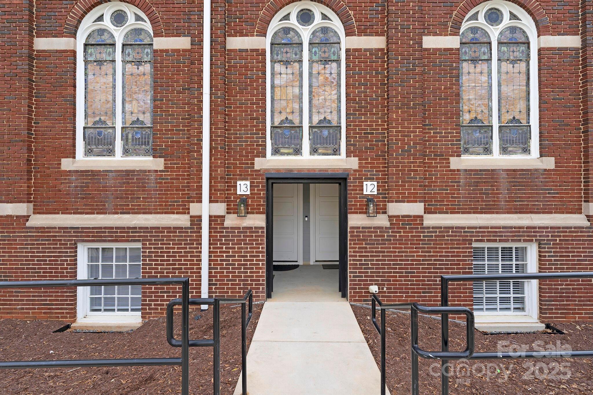 201 Grandin Road, Unit 13 Charlotte, NC 28208 - Photo 1 of 25 a view of a brick house with large windows