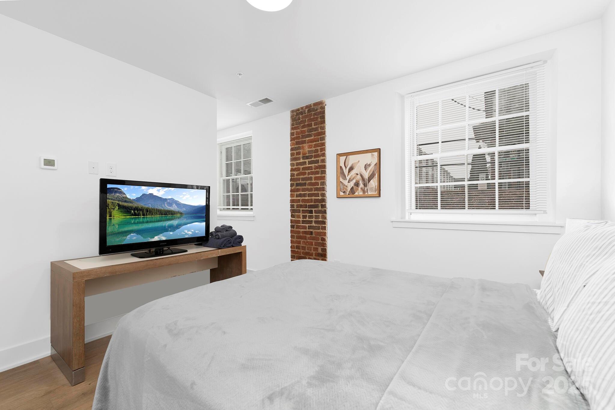 201 Grandin Road, Unit 13 Charlotte, NC 28208 - Photo 14 of 25 a bedroom with a flat screen tv and a window