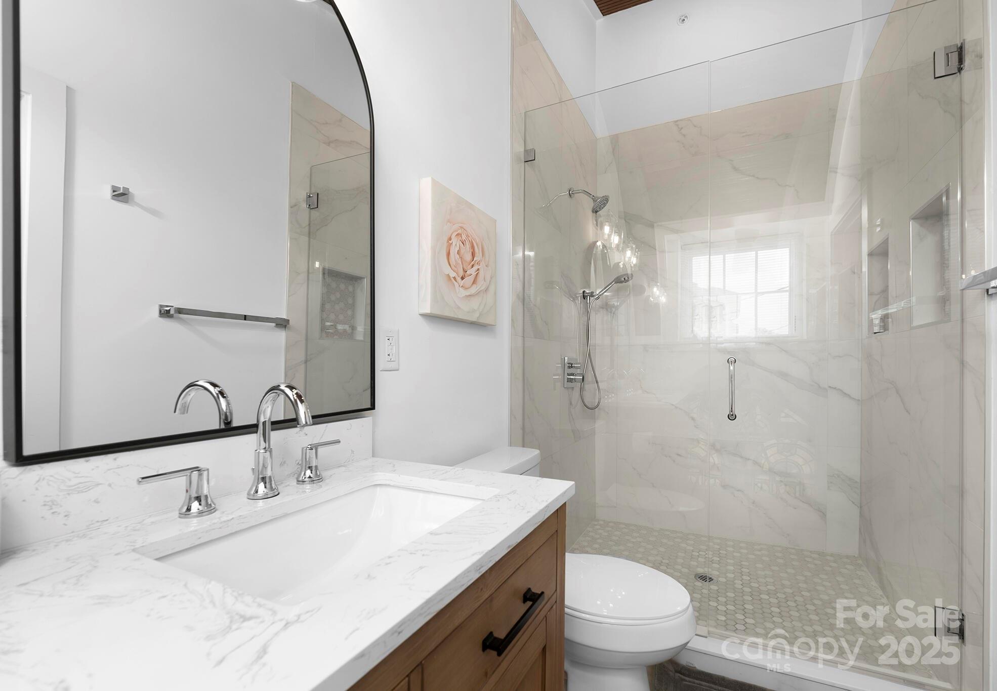 201 Grandin Road, Unit 13 Charlotte, NC 28208 - Photo 18 of 25 a bathroom with a granite countertop sink a toilet and shower