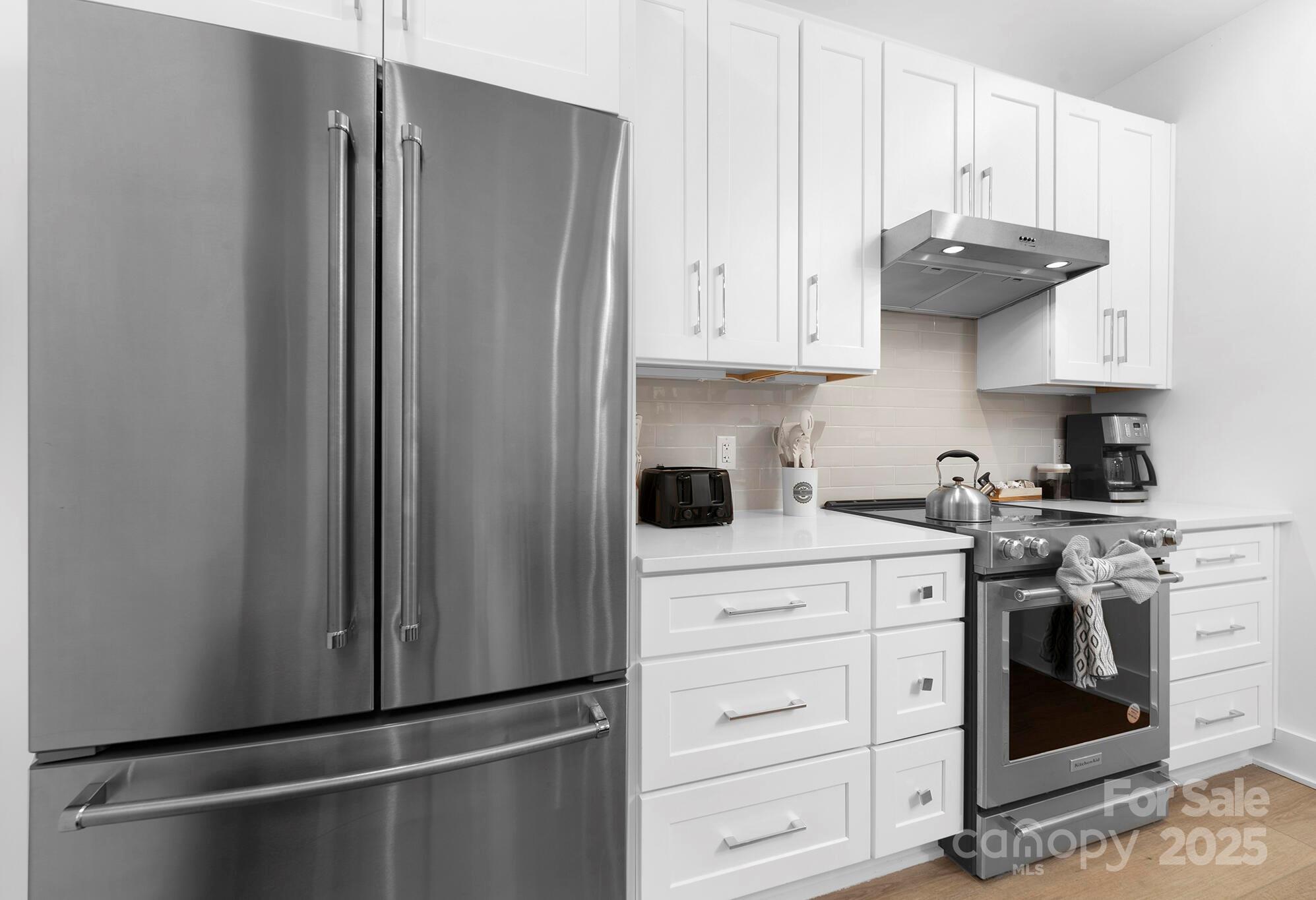 201 Grandin Road, Unit 13 Charlotte, NC 28208 - Photo 19 of 25 a kitchen with stainless steel appliances granite countertop a refrigerator and a stove top oven