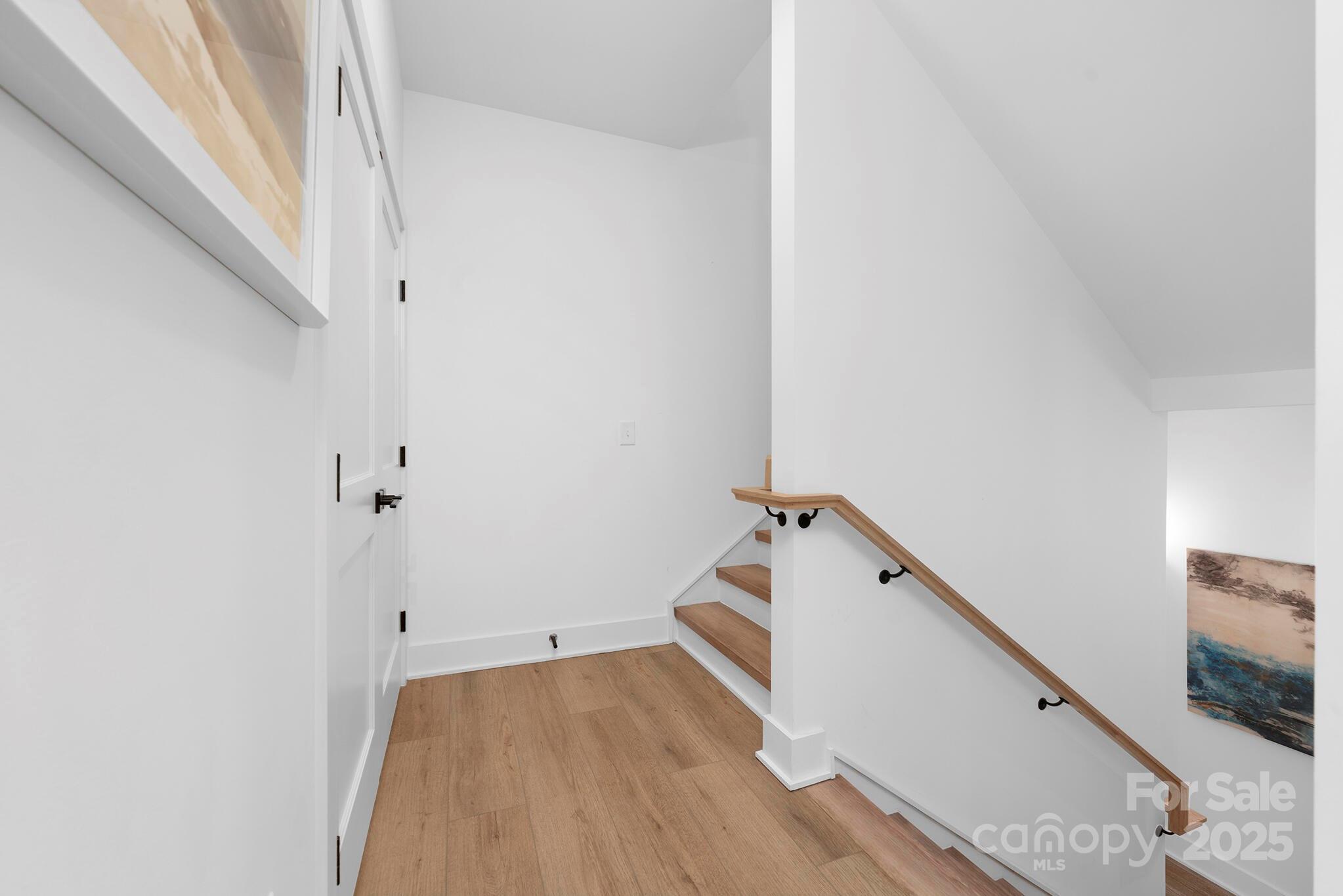 201 Grandin Road, Unit 13 Charlotte, NC 28208 - Photo 22 of 25 a view of a hallway with wooden floor and staircase