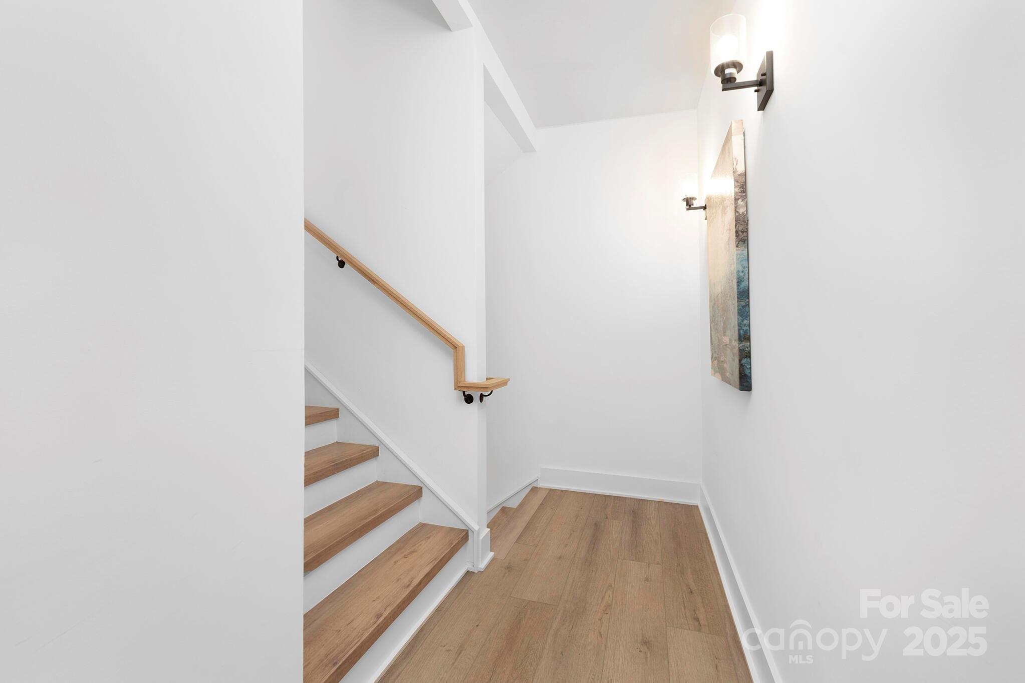 201 Grandin Road, Unit 13 Charlotte, NC 28208 - Photo 23 of 25 a view of a hallway with wooden floor and staircase