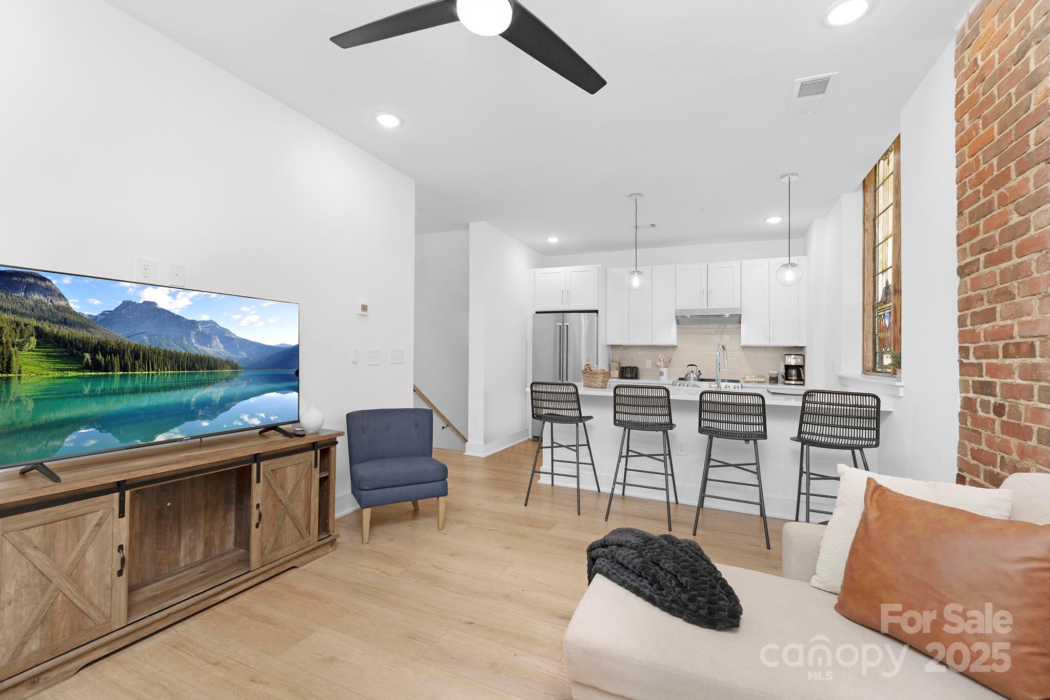 201 Grandin Road, Unit 13 Charlotte, NC 28208 - Photo 5 of 25 a living room with stainless steel appliances kitchen island granite countertop furniture and a kitchen view