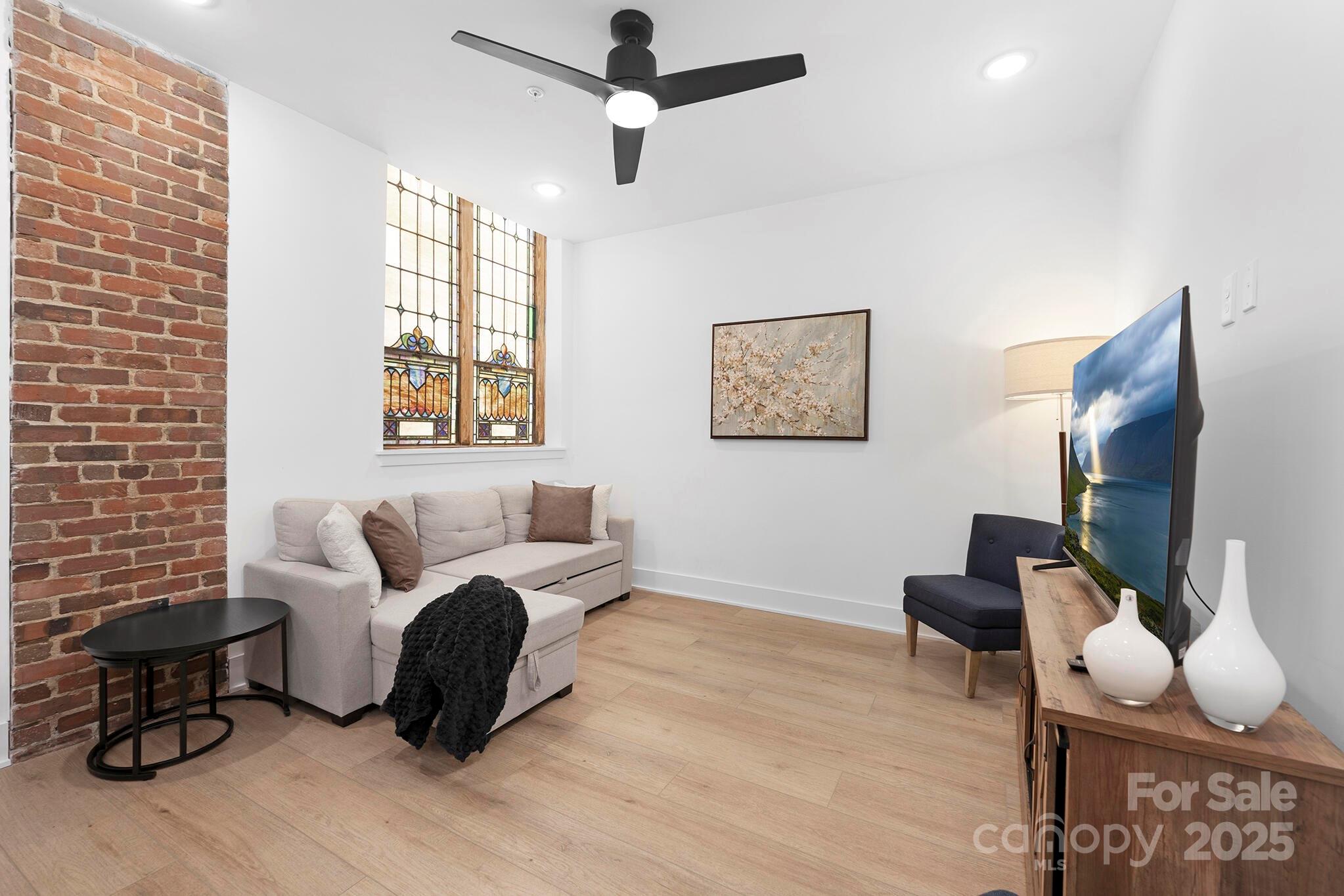 201 Grandin Road, Unit 13 Charlotte, NC 28208 - Photo 6 of 25 a living room with furniture a flat screen tv and a window