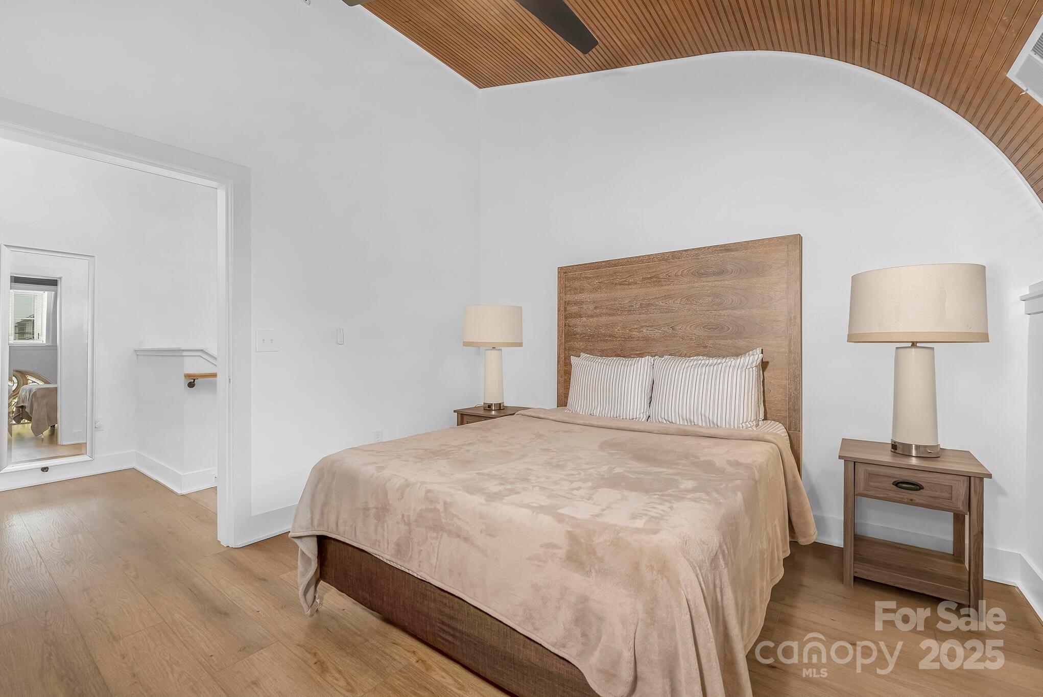 201 Grandin Road, Unit 13 Charlotte, NC 28208 - Photo 8 of 25 a bedroom with a bed and a night stand