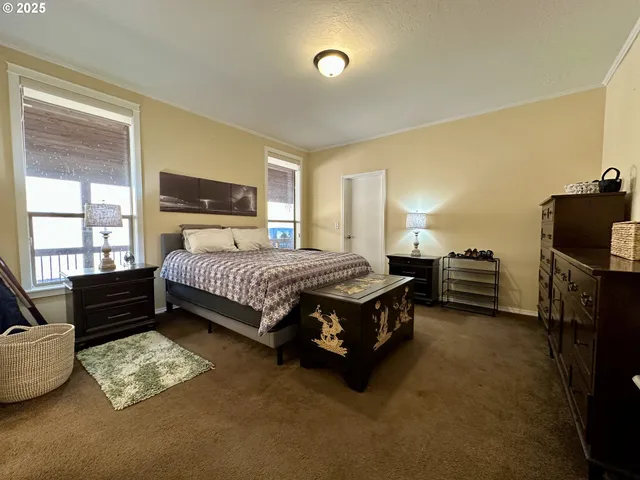 a bedroom with a bed dresser and a window