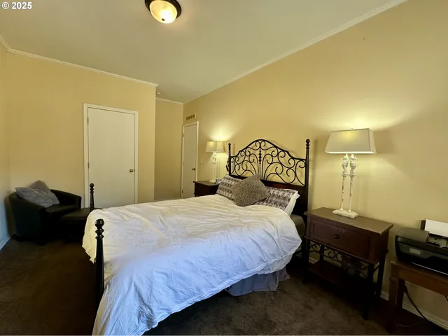 a bedroom with a bed and a lamp on table