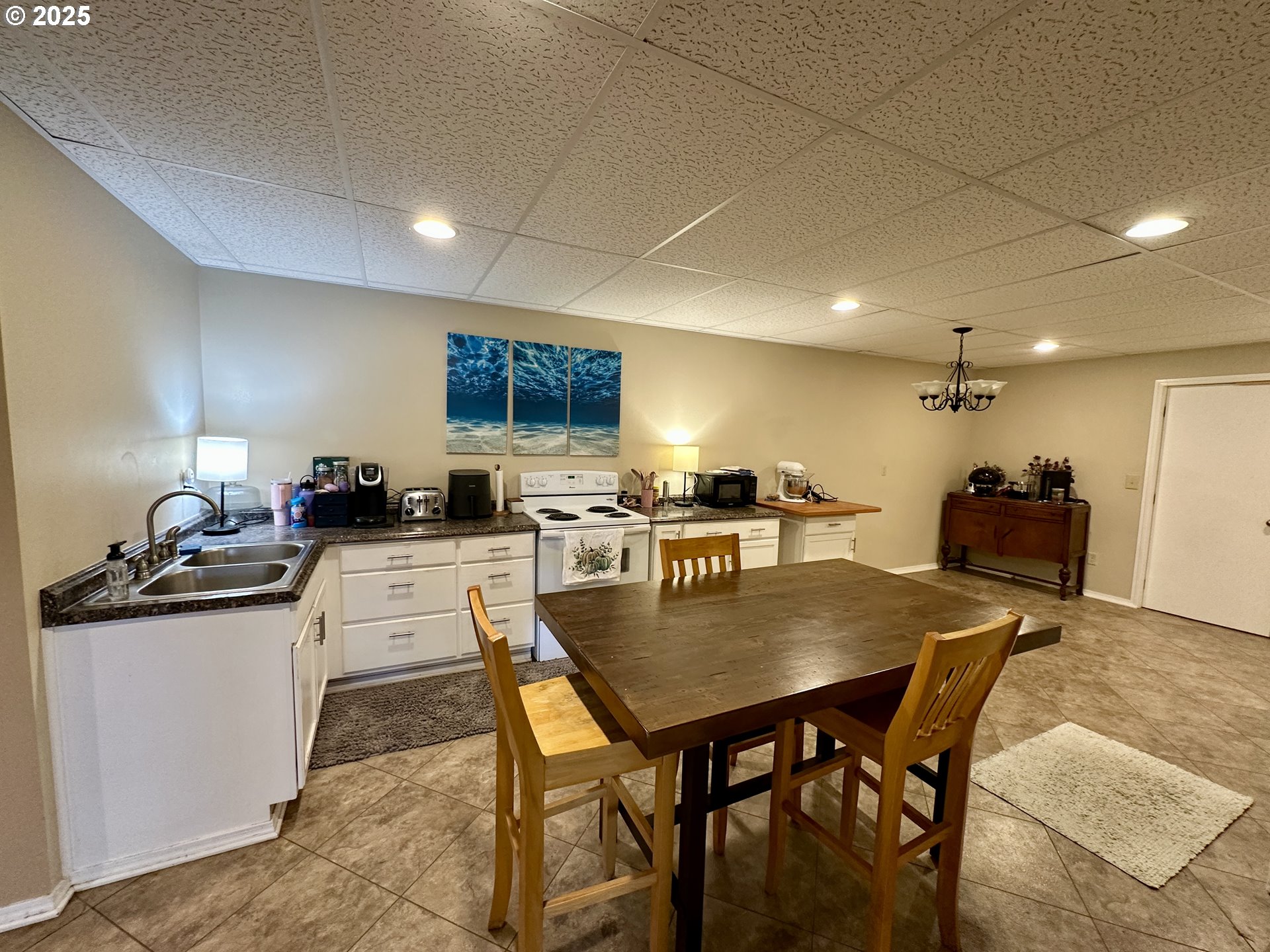 48144 East Pine Creek Road Halfway, OR 97834 - Photo 18 of 48 a kitchen with stainless steel appliances granite countertop a stove a sink a refrigerator a dining table and chairs with wooden floor