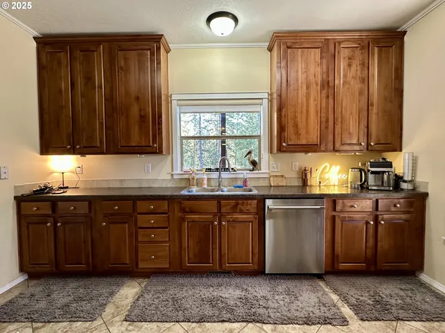 a kitchen with stainless steel appliances granite countertop wooden cabinets a sink and dishwasher