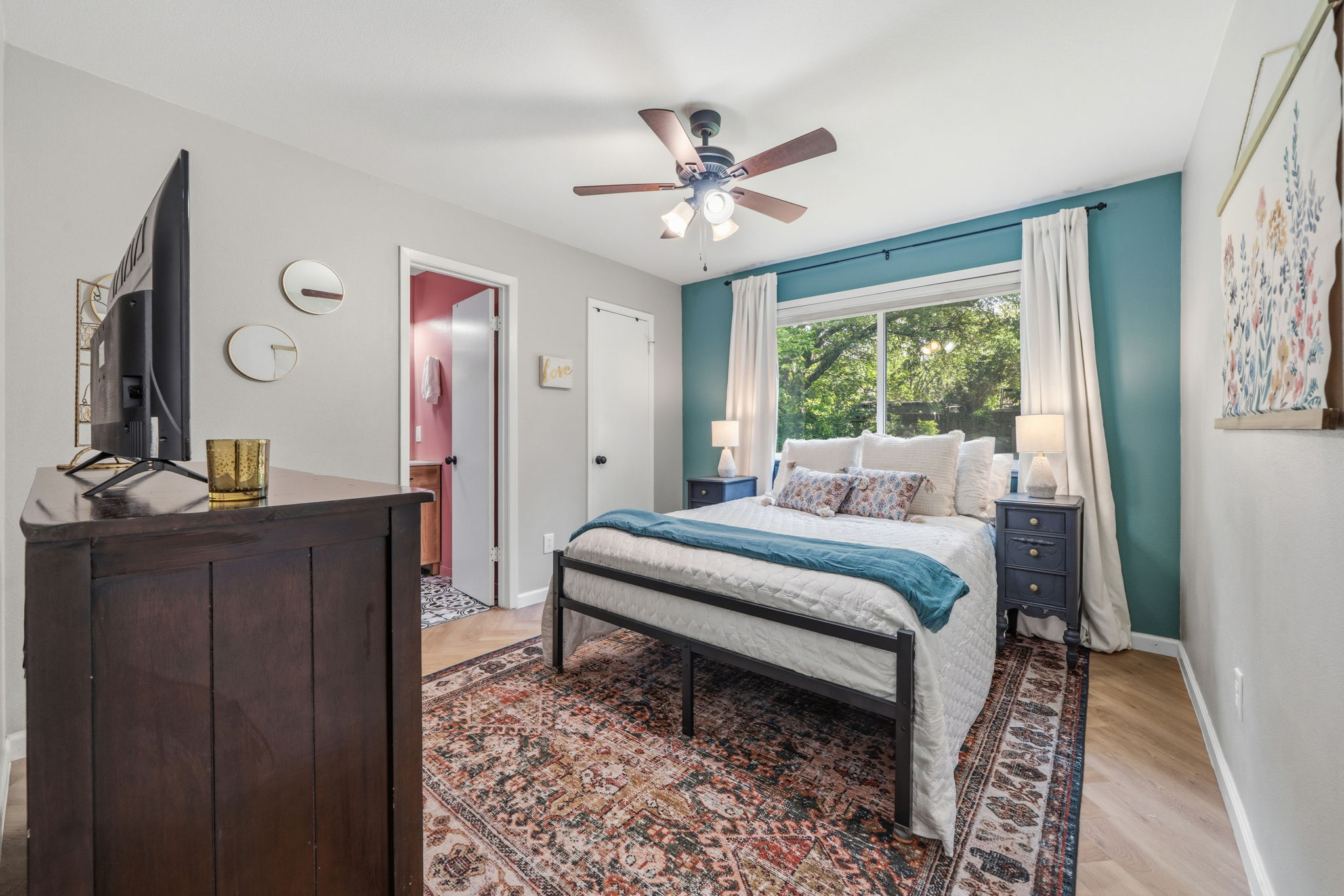 705 Dulwich Street Austin, TX 78748 - Photo 13 of 36 A well-lit sleeping area offers durable flooring and an overhead ceiling fan for comfort.