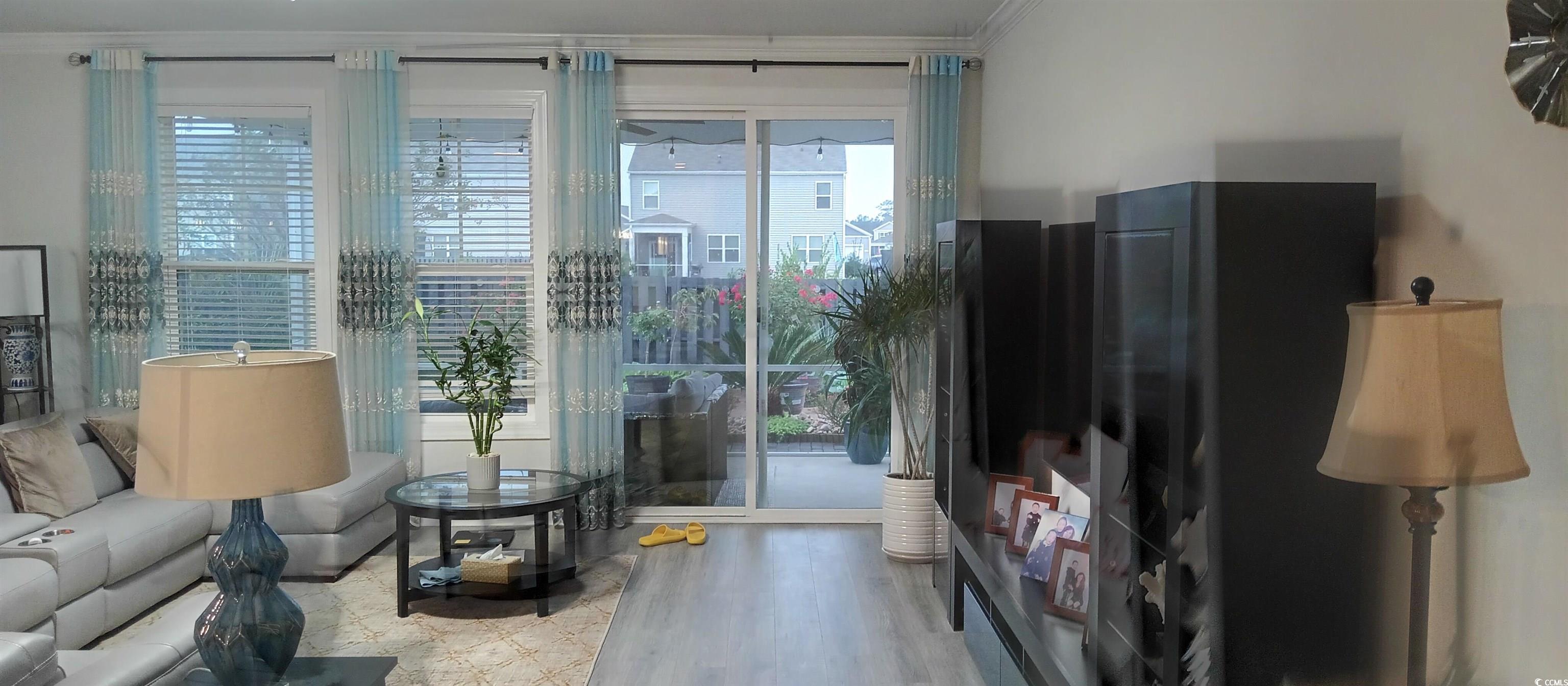 2808 Stellar Loop Myrtle Beach, SC 29577 - Photo 5 of 19 Living room featuring hardwood / wood-style floors and crown molding