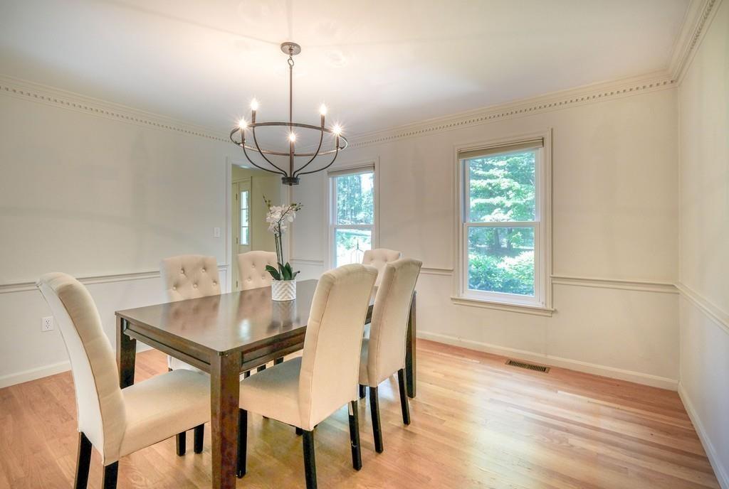 35 Hampshire Road Wayland, MA 01778 - Photo 5 of 33 a dining room with wooden floor a chandelier a wooden table and chairs