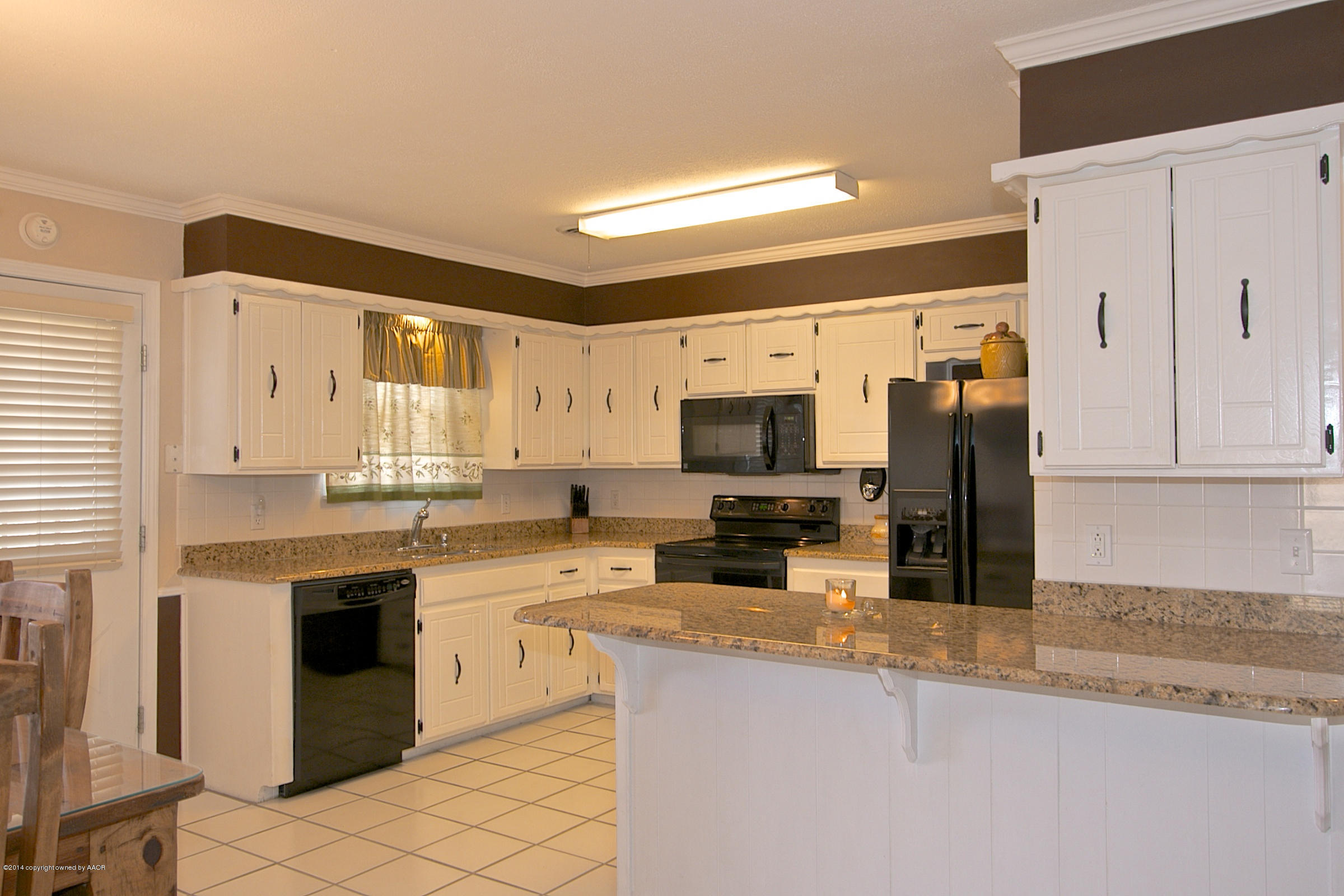 5701 South Fannin Street Amarillo, TX 79110 - Photo 1 of 15 a kitchen with stainless steel appliances granite countertop a stove top oven a sink a refrigerator and white cabinets