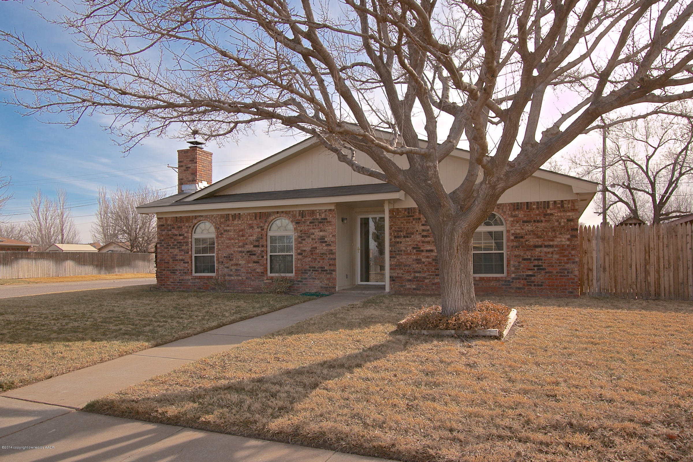 5701 South Fannin Street Amarillo, TX 79110 - Photo 13 of 15 a front view of a house with a yard and garage