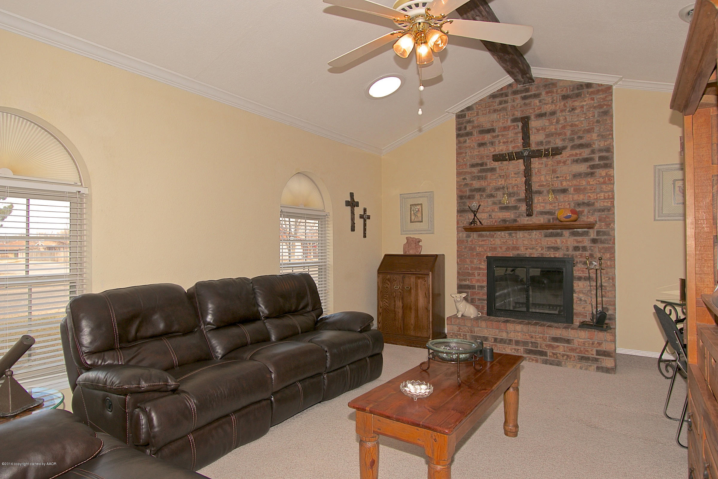 5701 South Fannin Street Amarillo, TX 79110 - Photo 2 of 15 a living room with furniture a fireplace and a chandelier