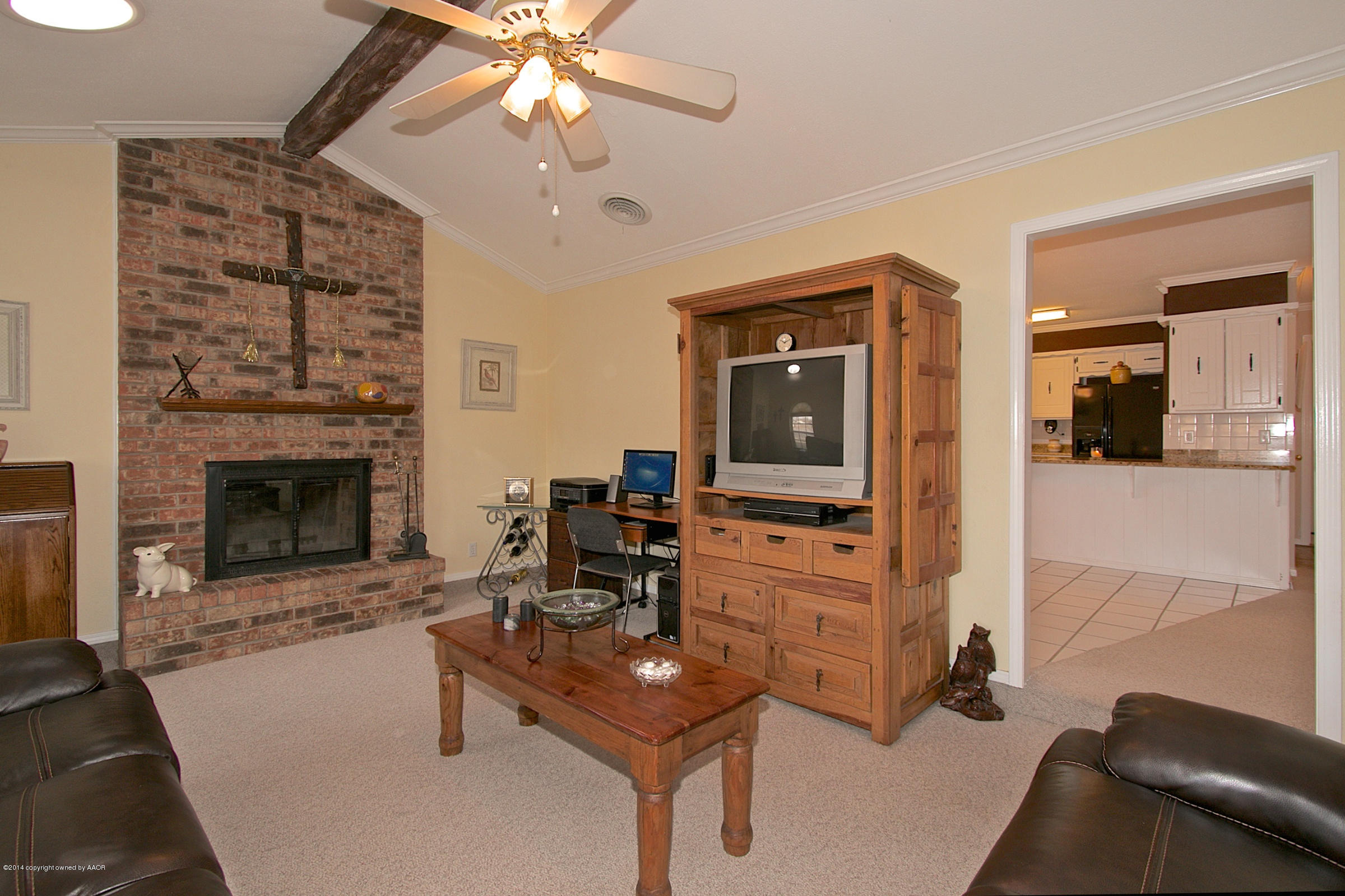 5701 South Fannin Street Amarillo, TX 79110 - Photo 3 of 15 a living room with furniture a flat screen tv and a fireplace