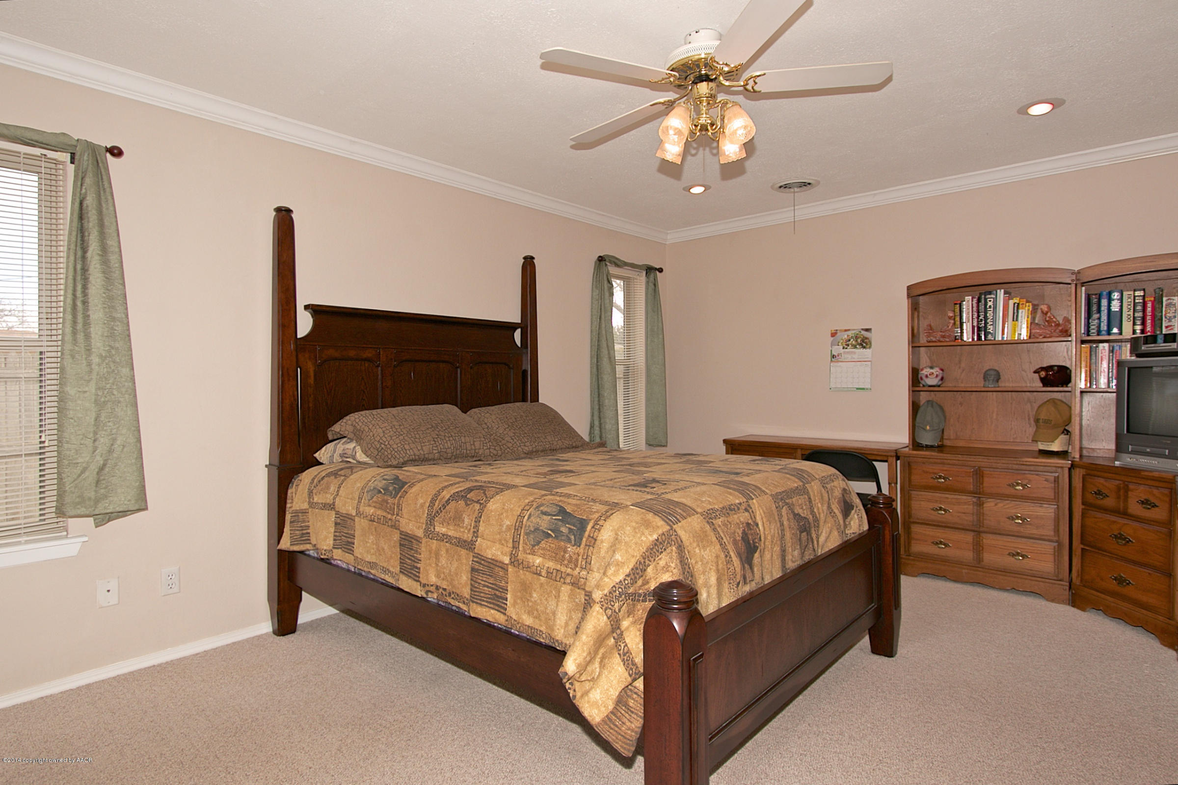 5701 South Fannin Street Amarillo, TX 79110 - Photo 7 of 15 a bedroom with a bed and a chandelier