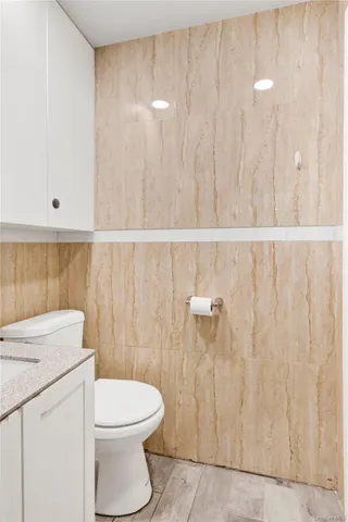 a bathroom with a toilet a sink and a shower curtain