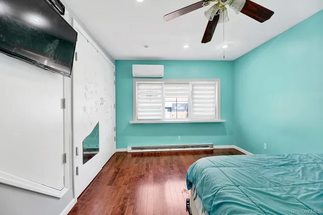 a view of a room with window wooden floor and front door