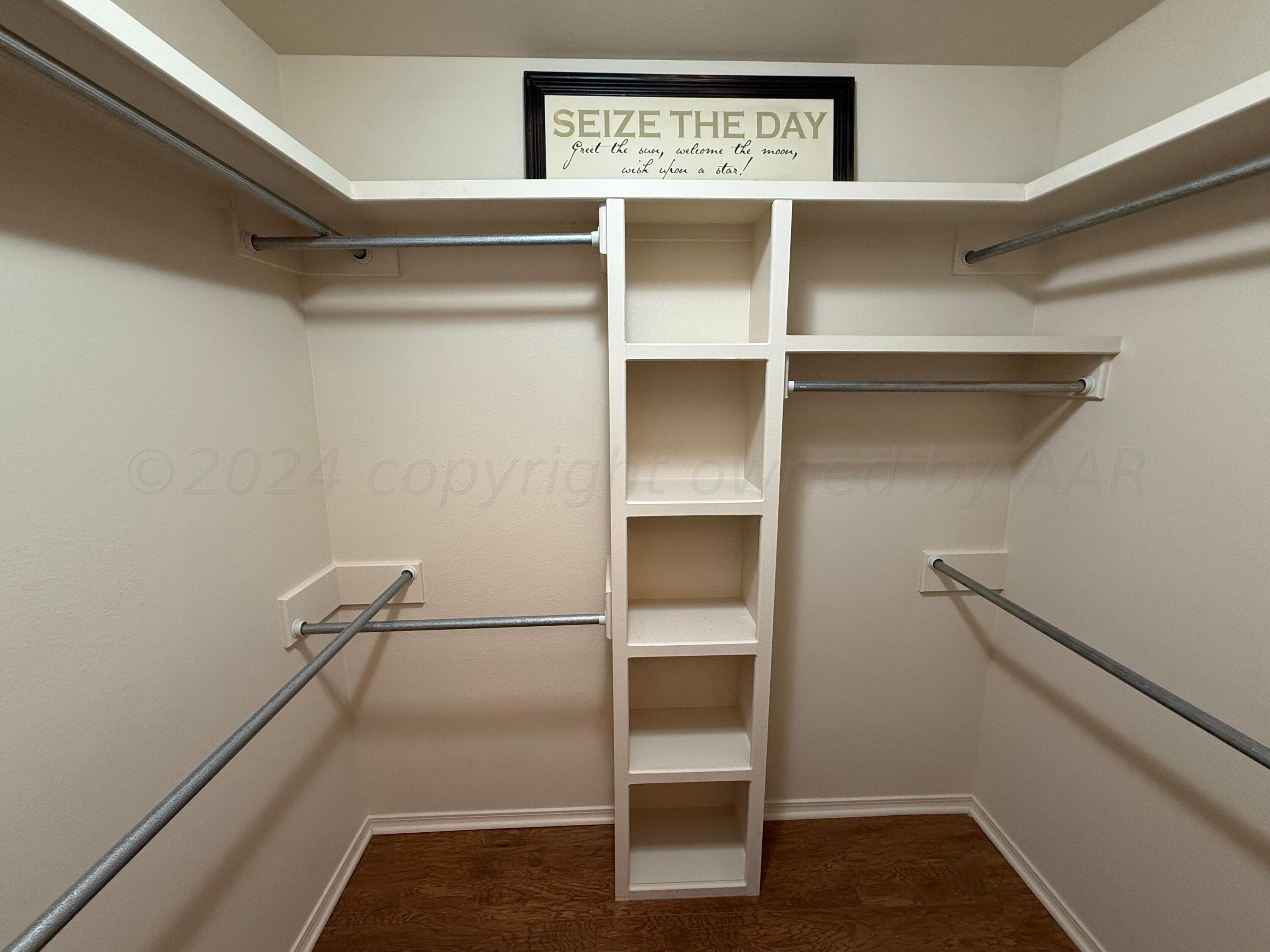 4528 Ida Louise Court Amarillo, TX 79110 - Photo 18 of 25 a view of walk in closet with empty racks