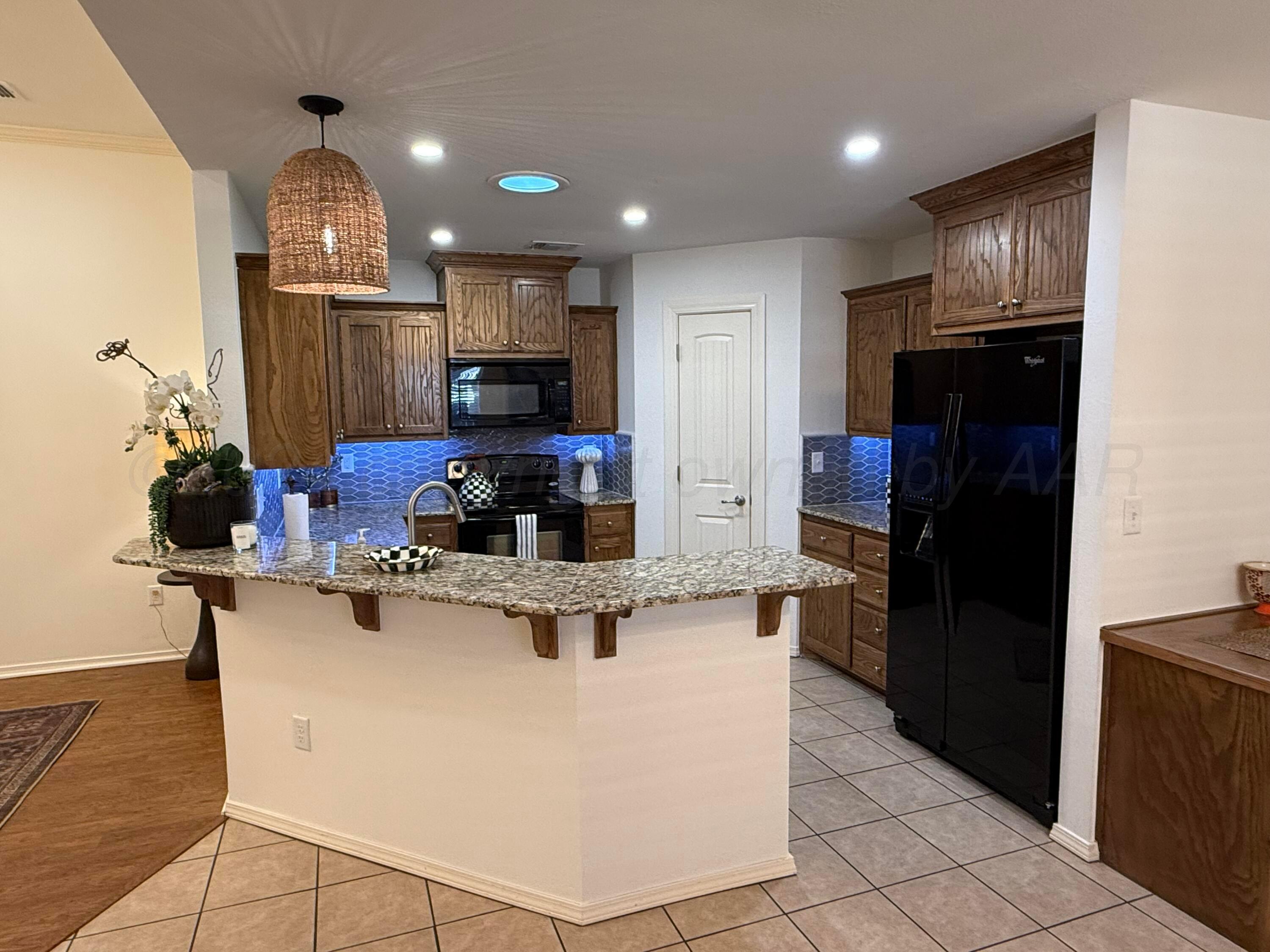 4528 Ida Louise Court Amarillo, TX 79110 - Photo 8 of 25 a large kitchen with stainless steel appliances granite countertop a refrigerator stove microwave and sink
