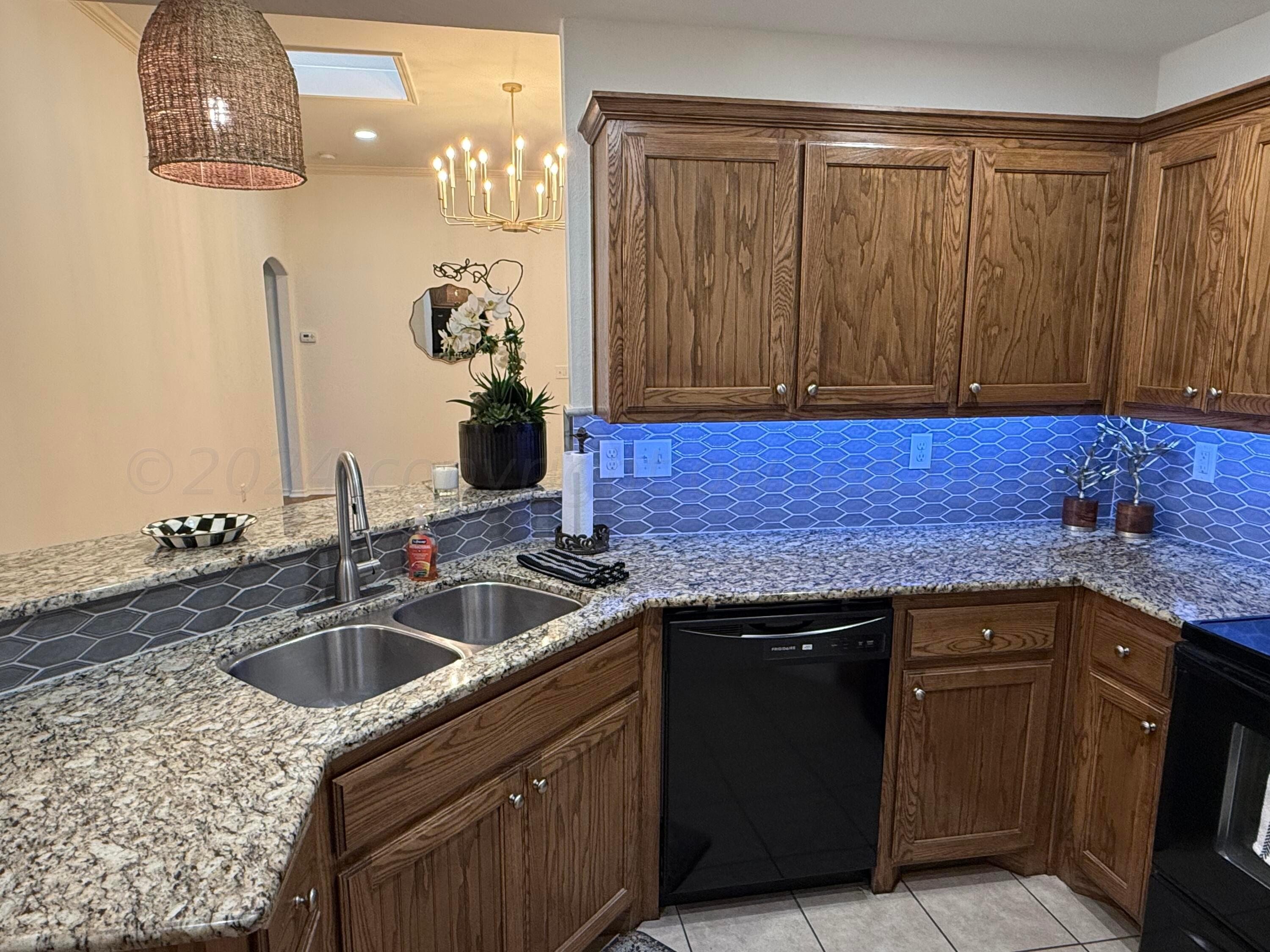 4528 Ida Louise Court Amarillo, TX 79110 - Photo 9 of 25 a kitchen with a sink and cabinets