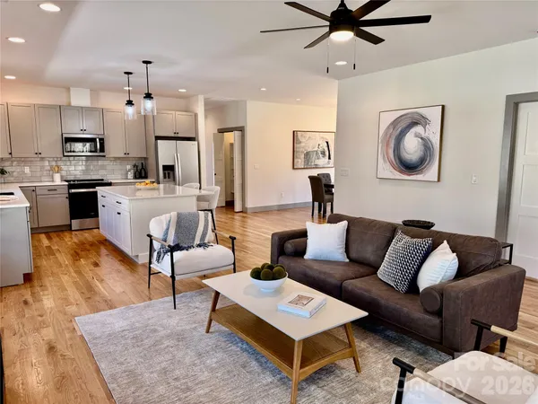 a living room with furniture and kitchen view