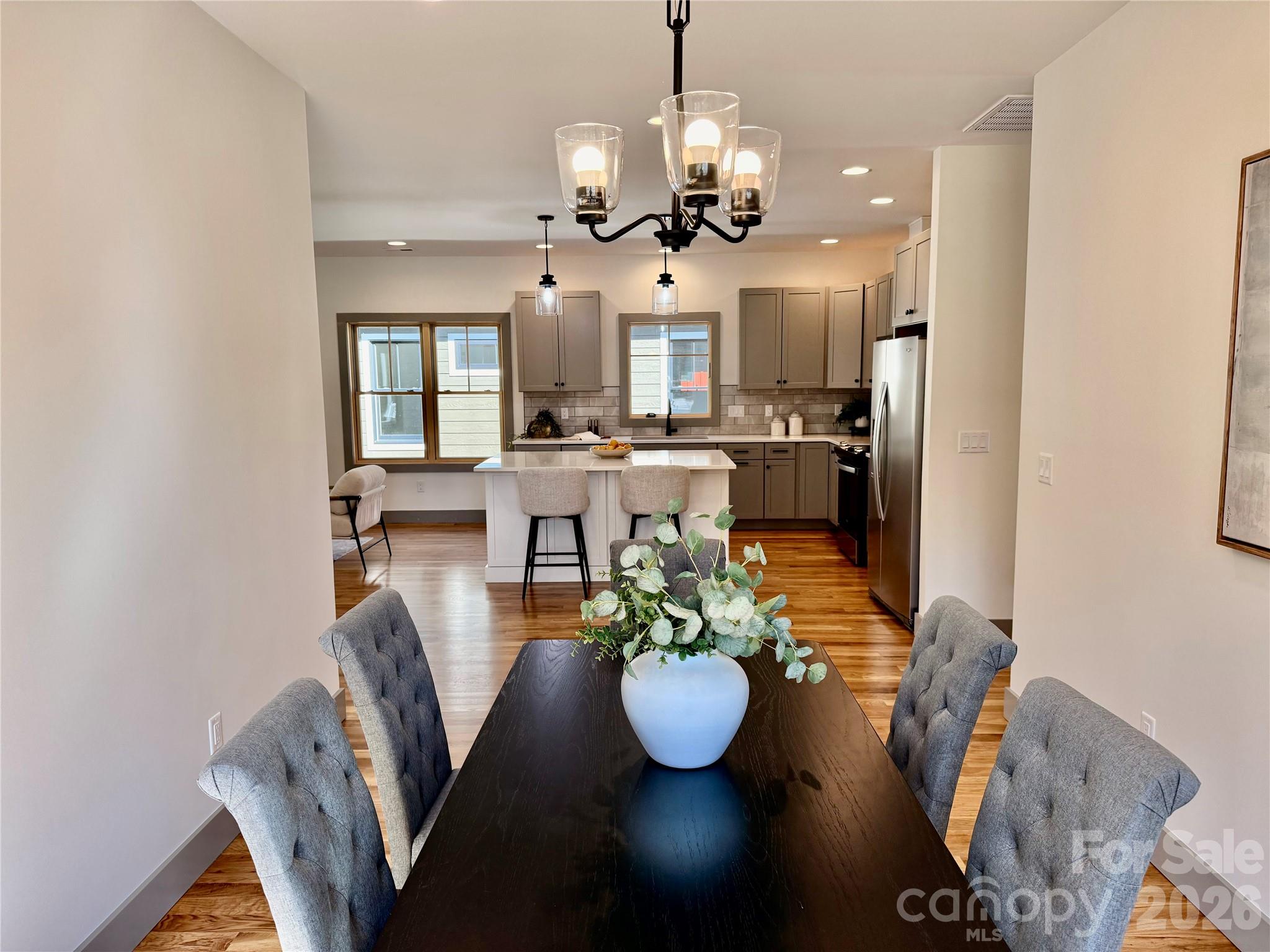 314 Gallimore Road Brevard, NC 28712 - Photo 11 of 38 a view of a dining room with furniture a chandelier and wooden floor