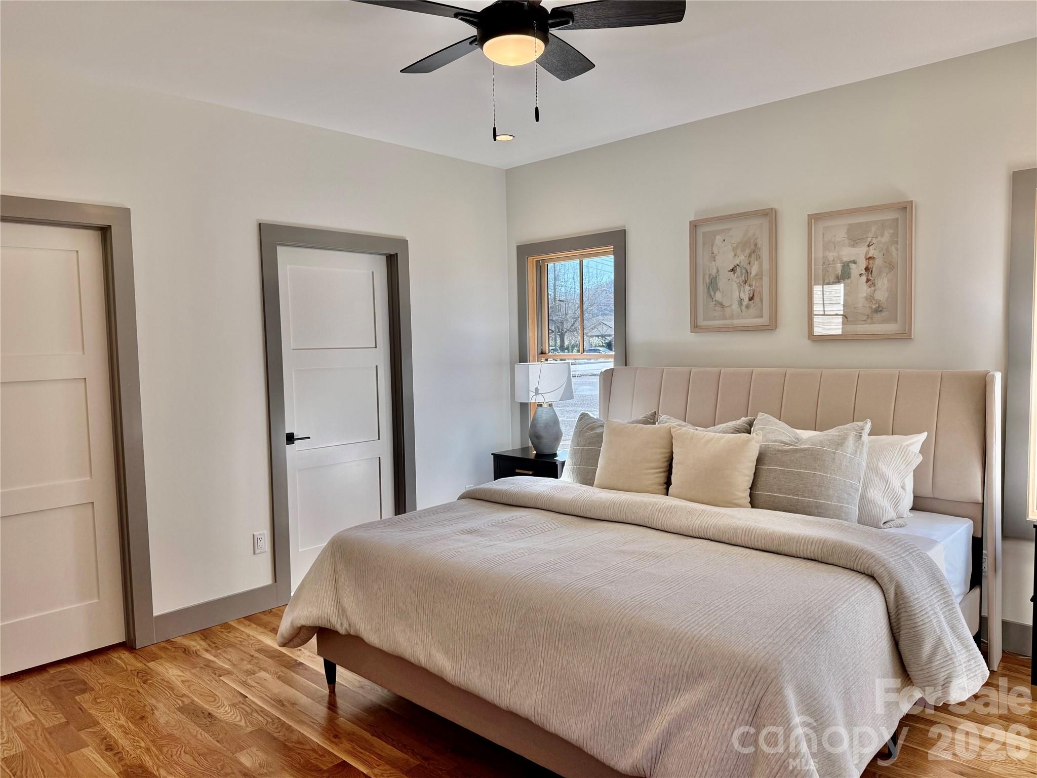 314 Gallimore Road Brevard, NC 28712 - Photo 19 of 38 a bedroom with a large bed and a chandelier