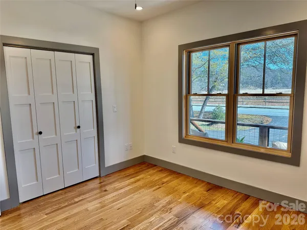 a view of a room with a window and ceiling fan