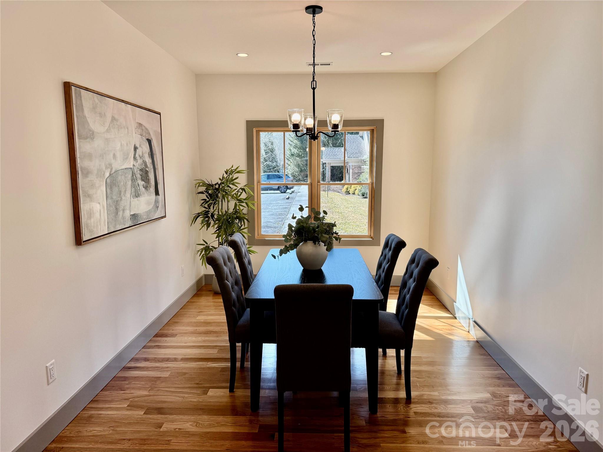 314 Gallimore Road Brevard, NC 28712 - Photo 10 of 38 a dining room with furniture a potted plant and wooden floor