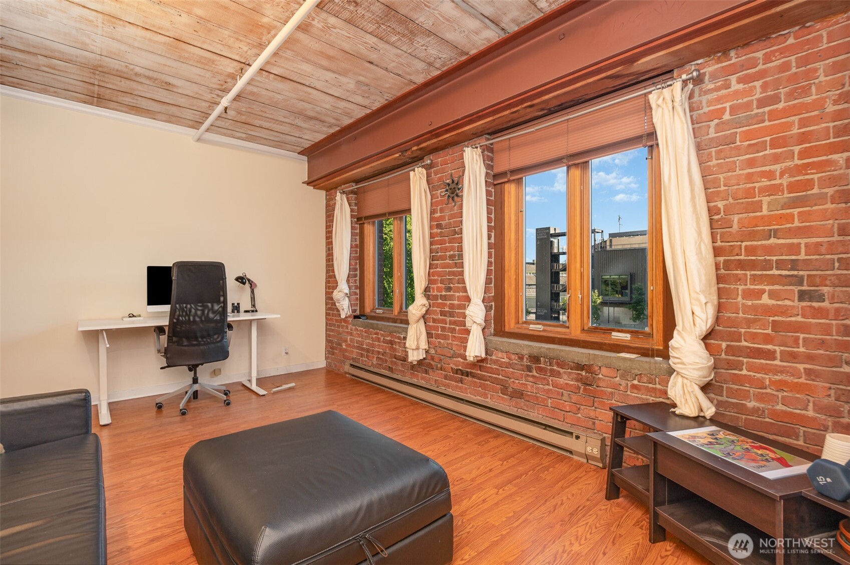 1507 Western Avenue, Unit R203 Seattle, WA 98101 - Photo 11 of 18 a living room with furniture and a flat screen tv