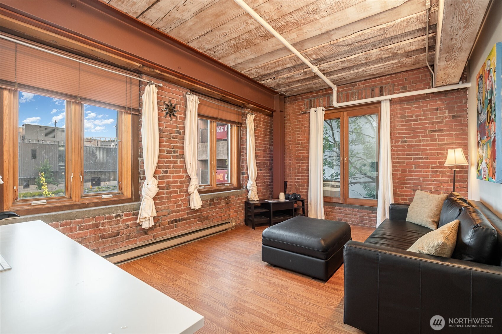 1507 Western Avenue, Unit R203 Seattle, WA 98101 - Photo 12 of 18 a living room with furniture and floor to ceiling windows