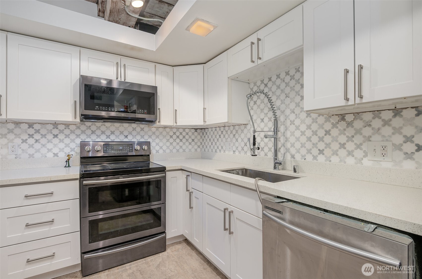 1507 Western Avenue, Unit R203 Seattle, WA 98101 - Photo 14 of 18 a kitchen with a sink stove and microwave