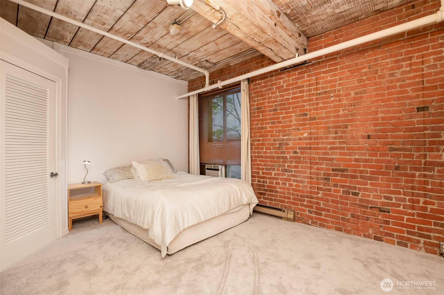 1507 Western Avenue, Unit R203 Seattle, WA 98101 - Photo 15 of 18 a bedroom with a bed and a wall painting