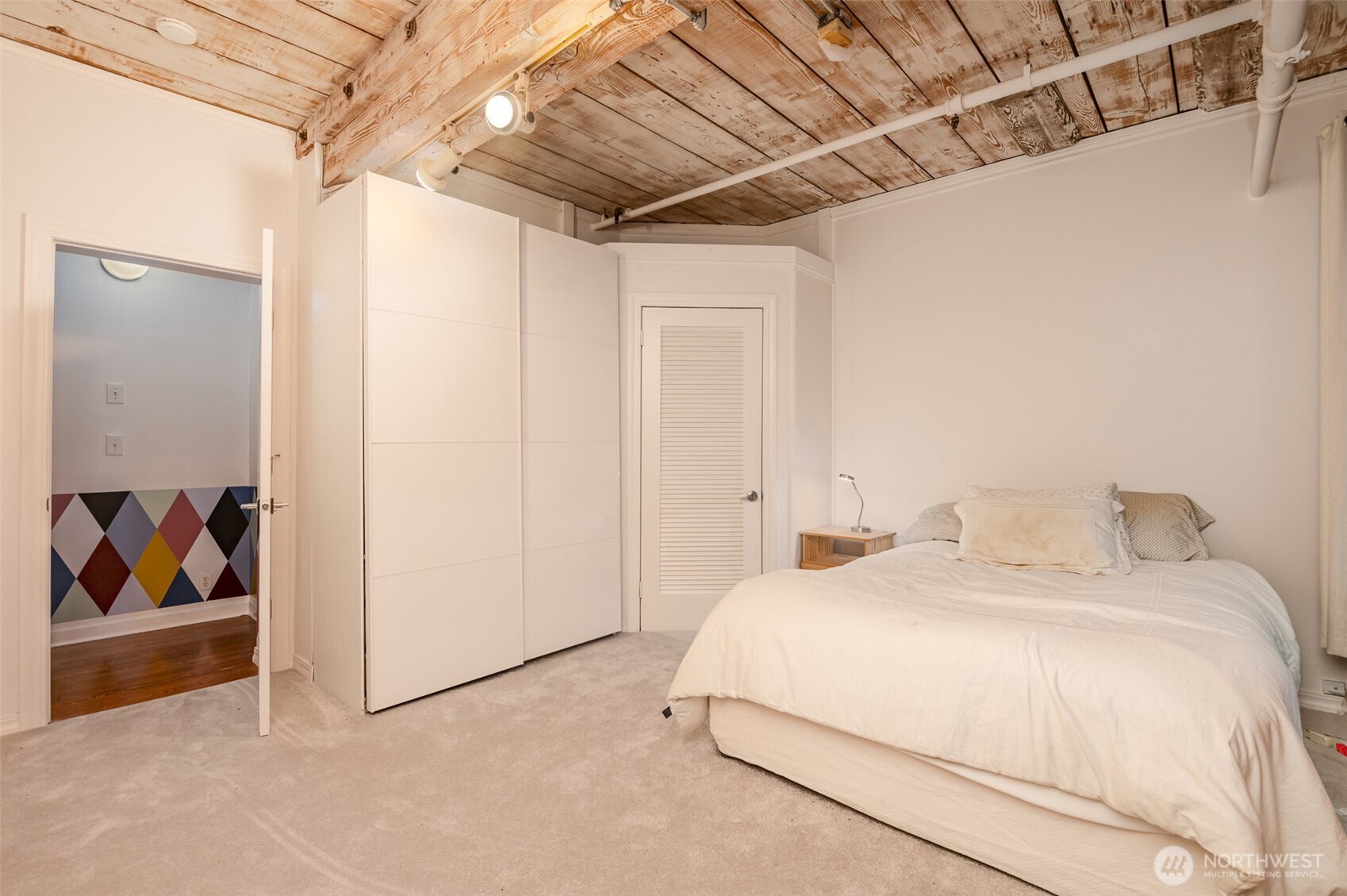 1507 Western Avenue, Unit R203 Seattle, WA 98101 - Photo 16 of 18 a bedroom with a bed and a painting on the wall