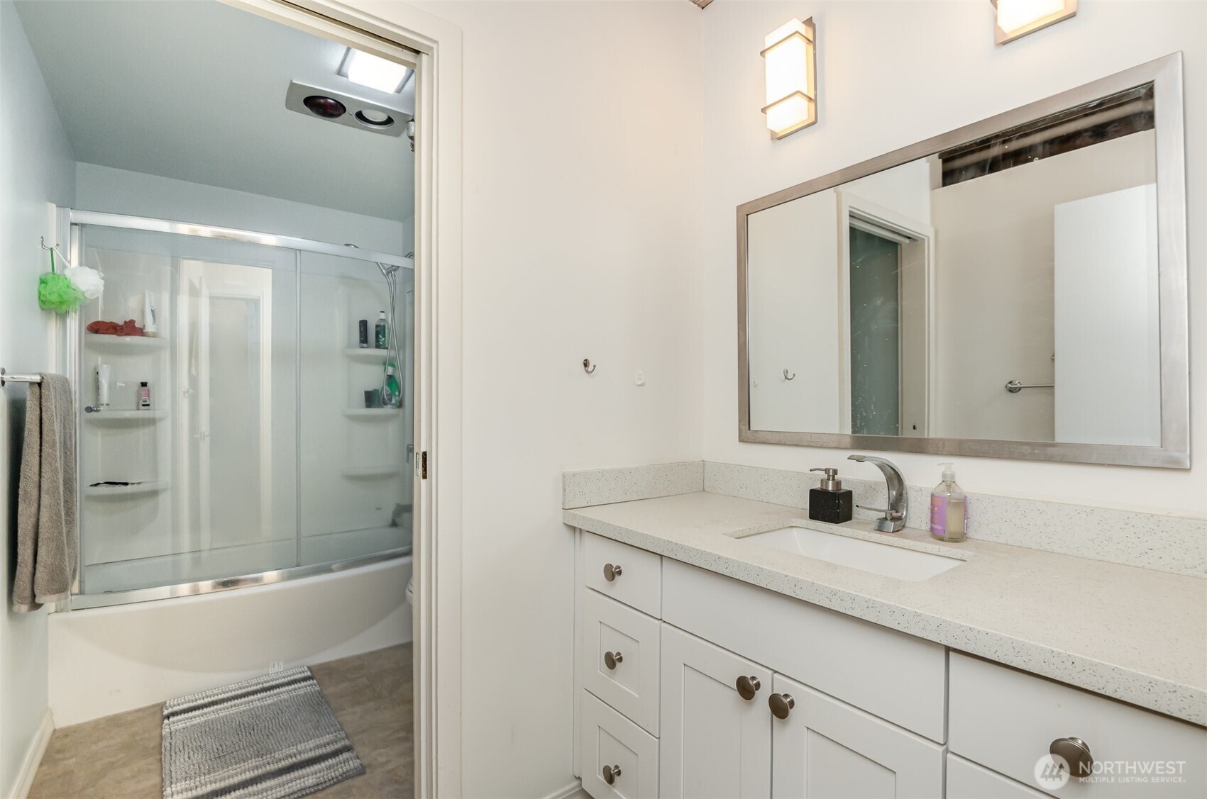 1507 Western Avenue, Unit R203 Seattle, WA 98101 - Photo 17 of 18 a bathroom with a sink and a mirror with bathtub