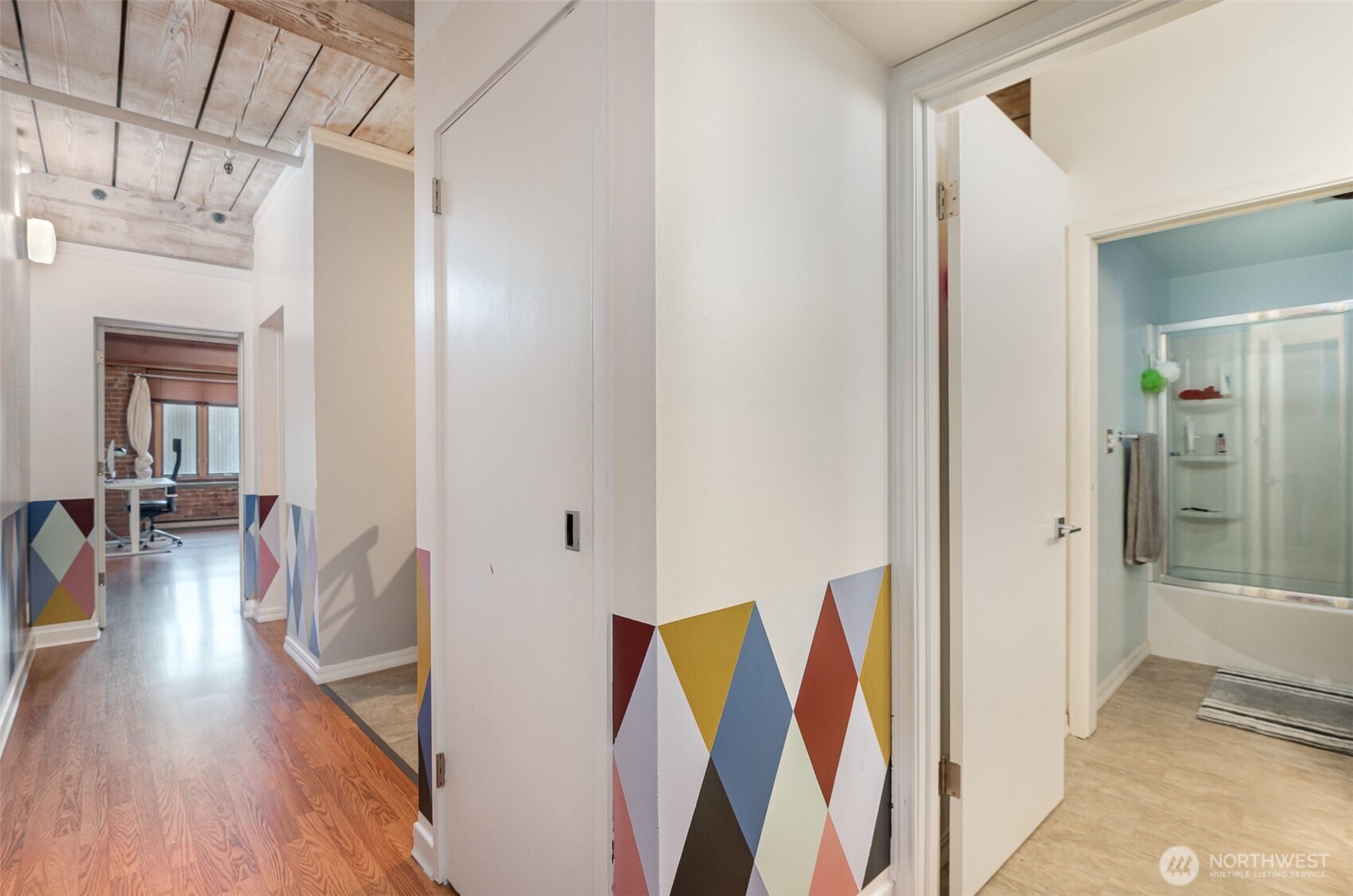 1507 Western Avenue, Unit R203 Seattle, WA 98101 - Photo 7 of 18 a living room with stainless steel appliances furniture and a wooden floor